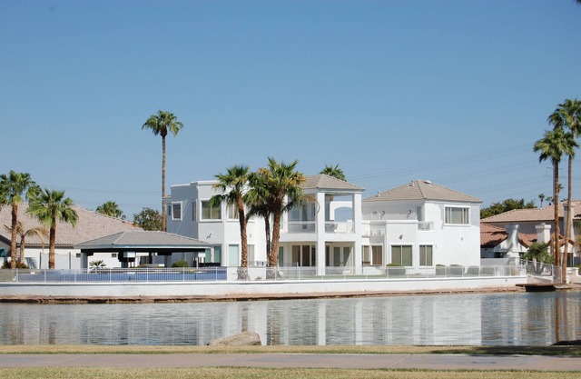 This GORGEOUS custom home is located on 3/4 acre waterfront in Gilbert Arizona