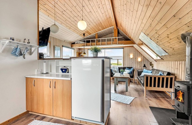 This small and cozy cottage is located in a unique location in Stauning. From the living room