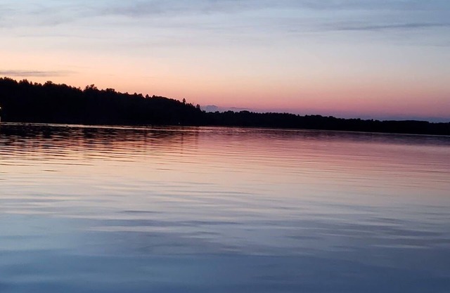 Three bedroom hide-a-way with spacious deck over looking Island Lake.