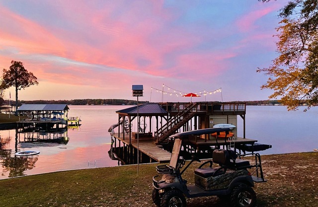 Two-story boathouse, golf cart, hot tub, kayaks, paddle boards, fishing lights!