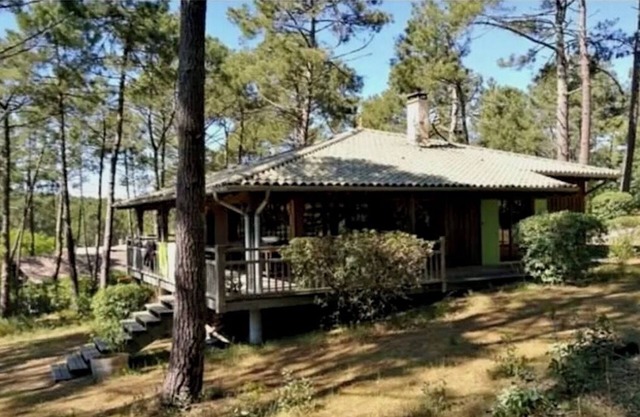 Typical house in a peaceful setting surrounded by pine trees.