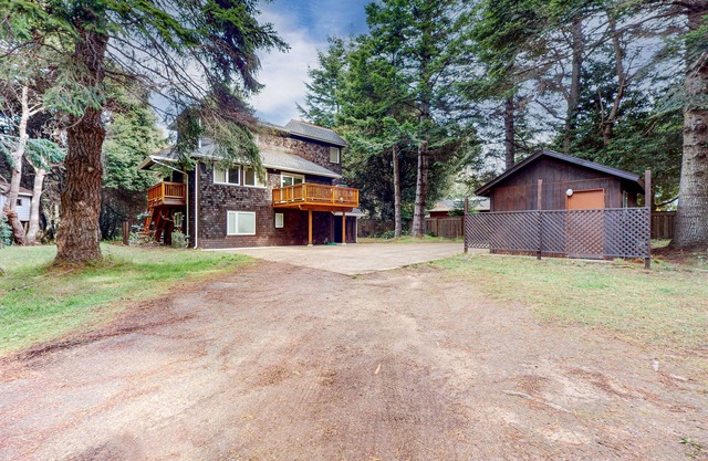 Updated home on an acre of forest with hot tub and deck - near the beach