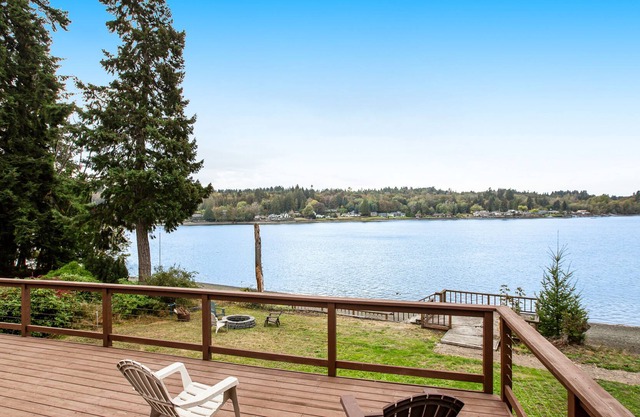 Vibrant waterfront home with large deck, woodstove & striking sunset views