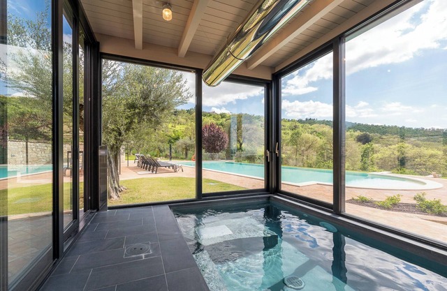 Villa Lago is set against a hillside of luscious greenery olive groves