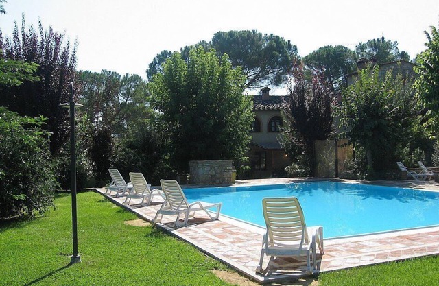 Villa Saveria A: A characteristic cottage surrounded by the greenery.