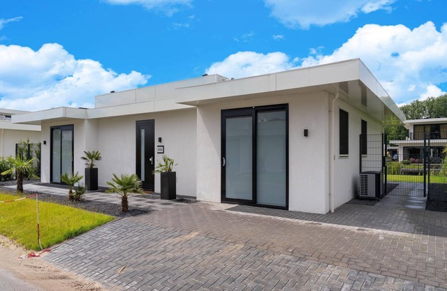 Villa with covered terrace and jetty on the water