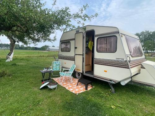 Vintage caravan in old orchard at farm Huize Blokland