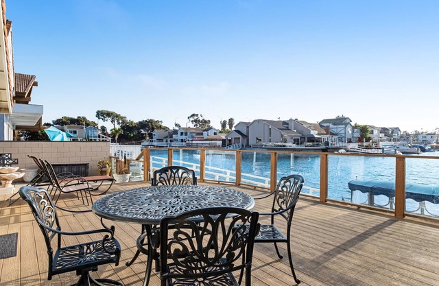 Waterfront home with kayaks, boat dock and large sun deck with harbor views