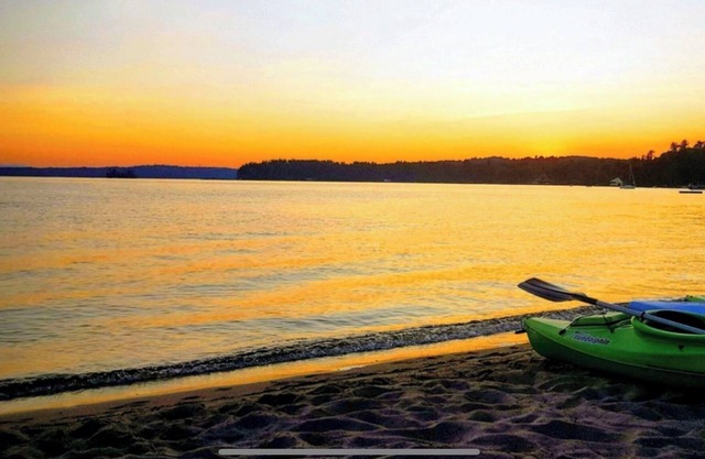 Waterfront Lake Winnipesaukee cabins on private sandy beach with dock