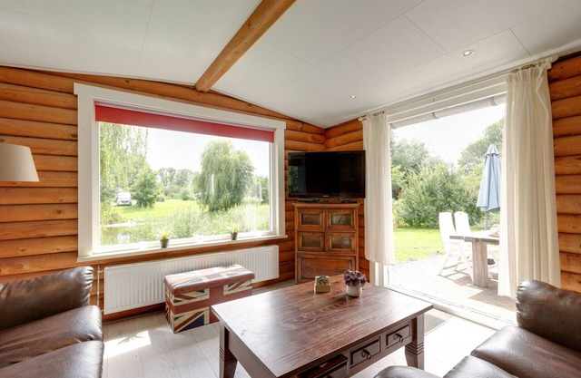 Wooden tree trunk bungalow at fish pond