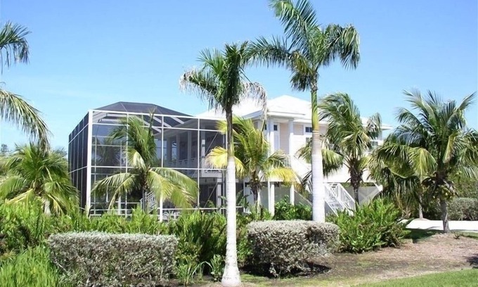 Sanibel House | Key West Style Home. With Screened Heated Pool. Only a 6 Minute Walk To Beach.