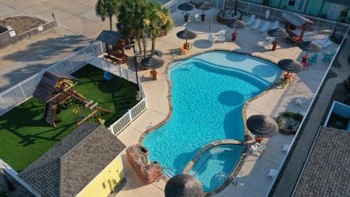 Port Aransas House | Shared Resort-Style Pool Playground Patio w Bar Tidal Times by AvantStay