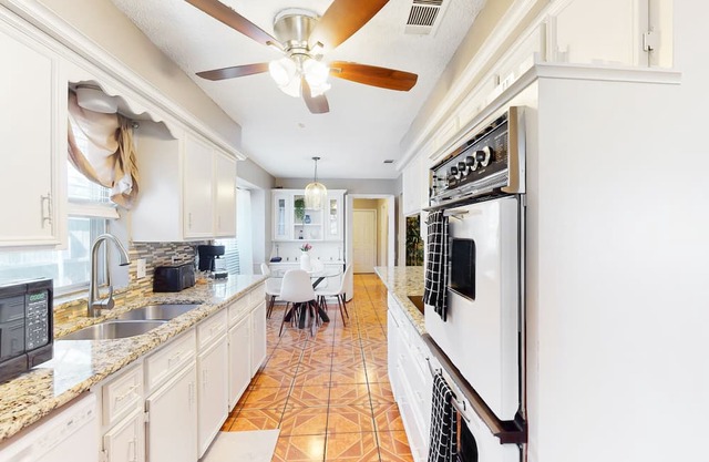 Private home with enclosed backyard, gas grill, sunny interior, & smart TVs